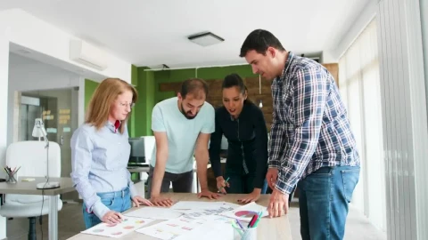 Free Video Stock team collaborates on idea in casual office Live Wallpaper - Free Live Wallpaper
