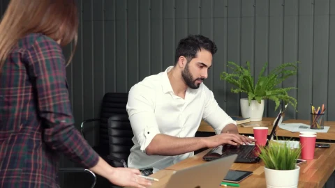 Free Video Stock team comes to help man working on laptop Live Wallpaper - Free Live Wallpaper