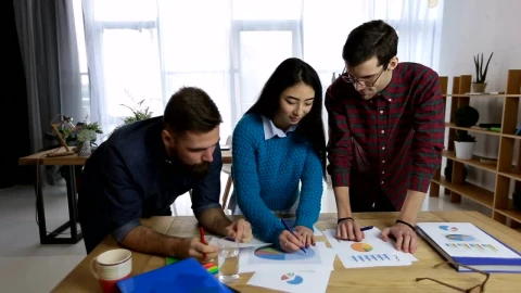Free Video Stock team reviewing charts and reports Live Wallpaper - Free Live Wallpaper