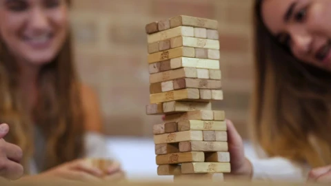 Free Video Stock tearing down a jenga tower in a fun match Live Wallpaper - Free Live Wallpaper
