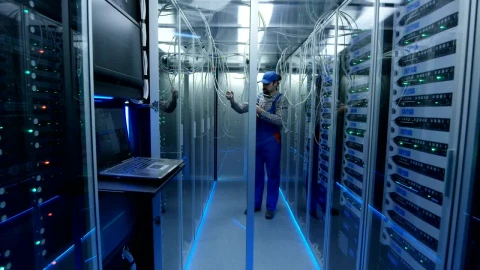 Free Video Stock technician working with cables in the data center Live Wallpaper - Free Live Wallpaper