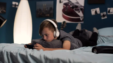Free Video Stock teen boy playing on his phone on the bed Live Wallpaper - Free Live Wallpaper