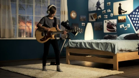 Free Video Stock teen boy playing the guitar on the bedroom Live Wallpaper - Free Live Wallpaper