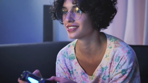 Free Video Stock teen with glasses playing video games on the sofa Live Wallpaper - Free Live Wallpaper