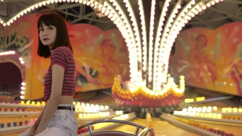 Free Video Stock teenage woman sitting in a mechanical fair game with the Live Wallpaper - Free Live Wallpaper