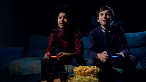 Free Video Stock teens playing a video game in a dark living room Live Wallpaper - Free Live Wallpaper