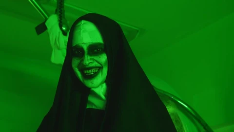 Free Video Stock terrifying woman disguised as a nun under a green light Live Wallpaper - Free Live Wallpaper
