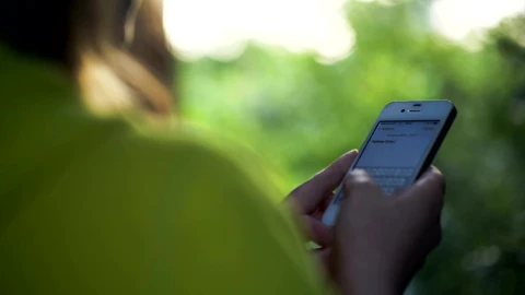Free Video Stock texting outdoors on a smartphone Live Wallpaper - Free Live Wallpaper
