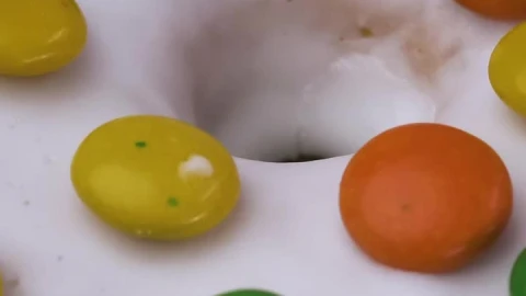 Free Video Stock texture of a glazed donut with colorful chocolates rotating Live Wallpaper - Free Live Wallpaper
