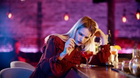Free Video Stock thoughtful woman playing with her drink in a bar Live Wallpaper - Free Live Wallpaper