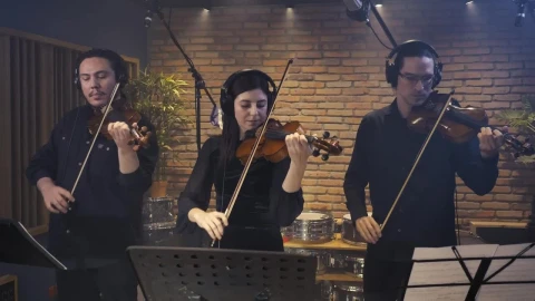Free Video Stock three violinists playing together in a recording studio Live Wallpaper - Free Live Wallpaper