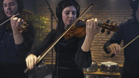 Free Video Stock three violinists recording a song in a studio Live Wallpaper - Free Live Wallpaper