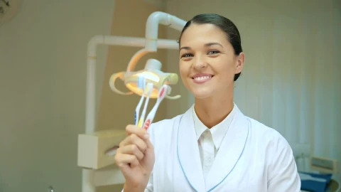 Free Video Stock thumb up of a dentist showing toothbrushes Live Wallpaper - Free Live Wallpaper