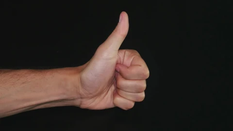 Free Video Stock thumbs up against a dark background Live Wallpaper - Free Live Wallpaper