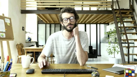 Free Video Stock tired and bored man in front of a computer Live Wallpaper - Free Live Wallpaper