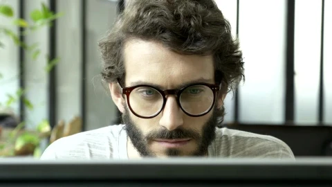 Free Video Stock tired man reading at the computer rest his eyes Live Wallpaper - Free Live Wallpaper