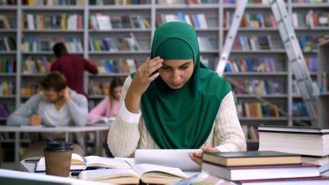 Free Video Stock tired woman reading in the library Live Wallpaper - Free Live Wallpaper