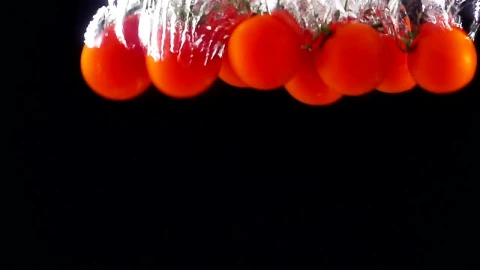 Free Video Stock tomatoes falling through water black background Live Wallpaper - Free Live Wallpaper