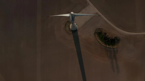 Free Video Stock top aerial shot of a wind turbine spinning Live Wallpaper - Free Live Wallpaper