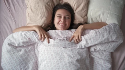Free Video Stock top shot of a woman waking up in the morning Live Wallpaper - Free Live Wallpaper