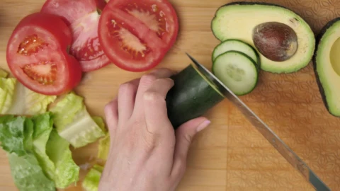 Free Video Stock top view of a woman slicing vegetables Live Wallpaper - Free Live Wallpaper