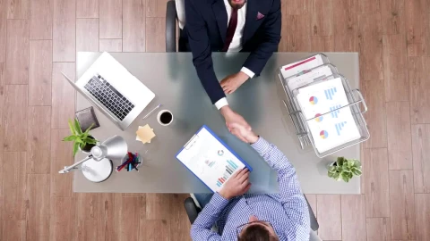Free Video Stock top view of business handshake and client meeting Live Wallpaper - Free Live Wallpaper
