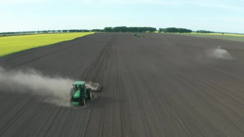 Free Video Stock tractor driving along a dusty field Live Wallpaper - Free Live Wallpaper