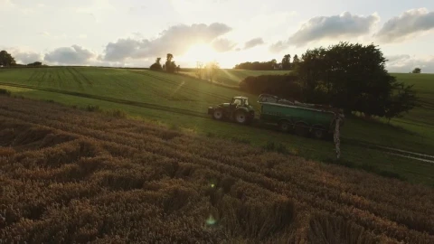 Free Video Stock tractor driving over green fields Live Wallpaper - Free Live Wallpaper
