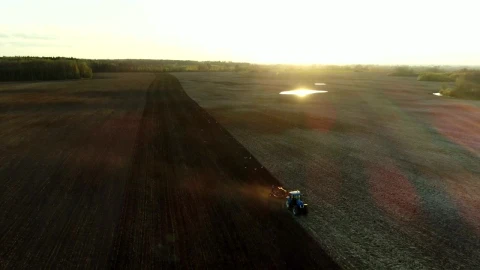 Free Video Stock tractor working in the field with sunbeams Live Wallpaper - Free Live Wallpaper