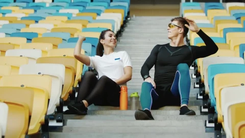 Free Video Stock trainer hi fives winner after race sitting on stadium stairs Live Wallpaper - Free Live Wallpaper