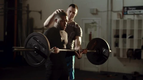 Free Video Stock trainer helping athlete with the barbell Live Wallpaper - Free Live Wallpaper