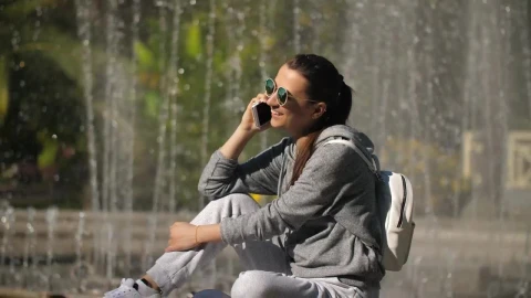 Free Stock Video Urban Woman Taking A Call Next To A Fountain Live Wallpaper - Free Live Wallpaper