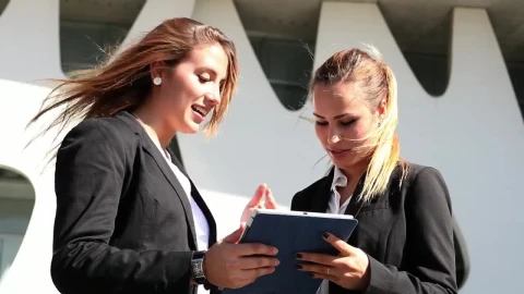 Free Stock Video Two Business Women Commenting On Something On A Tablet Live Wallpaper - Free Live Wallpaper