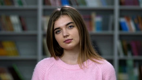 Free Stock Video Young Woman Smiling Into The Camera In A Library Live Wallpaper - Free Live Wallpaper