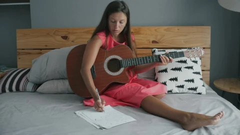 Free Stock Video Young Woman Playing The Guitar On The Bed Live Wallpaper - Free Live Wallpaper