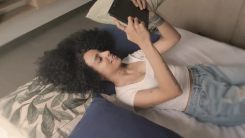 Free Stock Video Young Woman On A Video Call Lying On A Bed Live Wallpaper - Free Live Wallpaper
