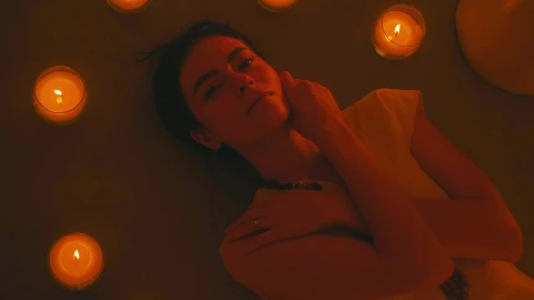 Free Stock Video Young Woman Lying On The Floor Among Many Candles Live Wallpaper - Free Live Wallpaper