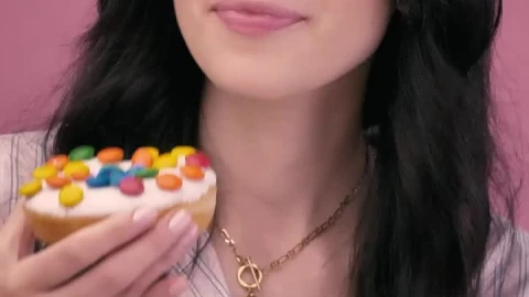 Free Stock Video Young Woman Biting A Donut On A Pink Background Live Wallpaper - Free Live Wallpaper