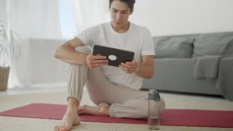 Free Stock Video Young Man Watching Yoga Videos For Practice Live Wallpaper - Free Live Wallpaper
