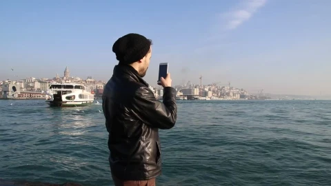 Free Stock Video Young Man Taking Photos On A Sunny Shore Live Wallpaper - Free Live Wallpaper