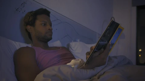 Free Stock Video Young Man Reading A Book Before Going To Sleep Live Wallpaper - Free Live Wallpaper