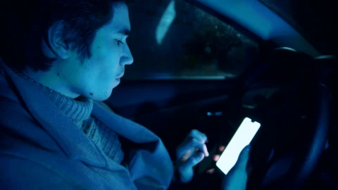Free Stock Video Young Male Driver Scrolling On His Smartphone Live Wallpaper - Free Live Wallpaper