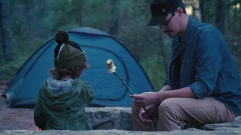 Free Stock Video Young Father Giving Roast Marshmallow To His Daughter Outdoors Live Wallpaper - Free Live Wallpaper