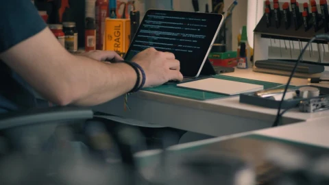 Free Stock Video Young Engineer Programming In His Workshop Seen Up Close Live Wallpaper - Free Live Wallpaper