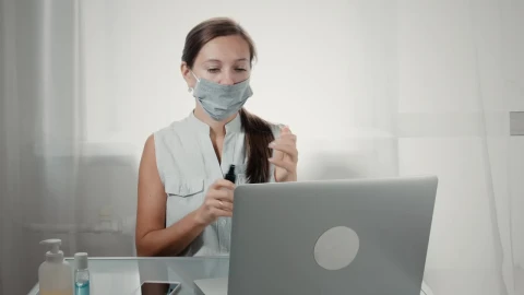 Free Stock Video Woman Using Hand Sanitizer Before Using Laptop Live Wallpaper - Free Live Wallpaper