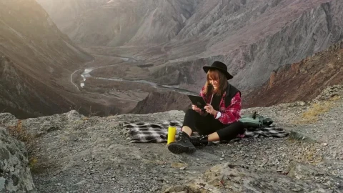Free Stock Video Woman Using A Tablet On Top Of A Crag Live Wallpaper - Free Live Wallpaper