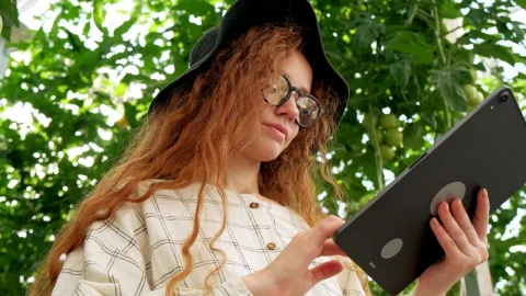 Free Stock Video Woman Using A Tablet At A Greenhouse Live Wallpaper - Free Live Wallpaper