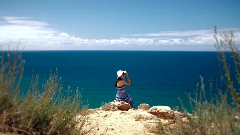 Free Stock Video Woman Sitting On The Edge Of A Cape Overlooking The Live Wallpaper - Free Live Wallpaper