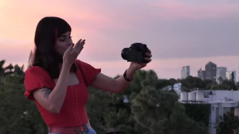Free Stock Video Woman Shooting A Blog With City Background At The Sunset Live Wallpaper - Free Live Wallpaper