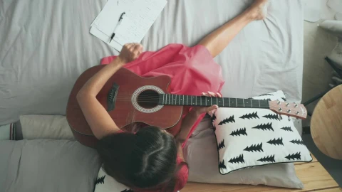 Free Stock Video Woman Playing The Acoustic Guitar On The Bed Live Wallpaper - Free Live Wallpaper